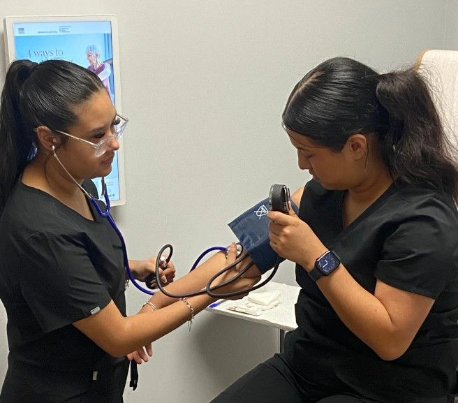students practicing taking blood pressure measurements students practicing taking blood pressure measurements